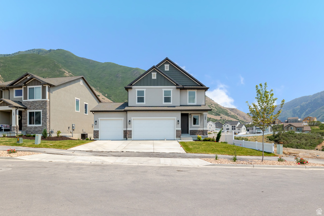 195 West Harmony Rdg Parkway, Unit 601 Mapleton, UT 84664 - Photo 1 of 23 Contemporary two-story residence featuring a dual garage and a neutral exterior palette of gray siding and stone accents