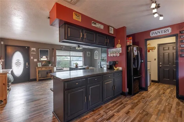 a kitchen with stainless steel appliances granite countertop a stove sink and cabinets