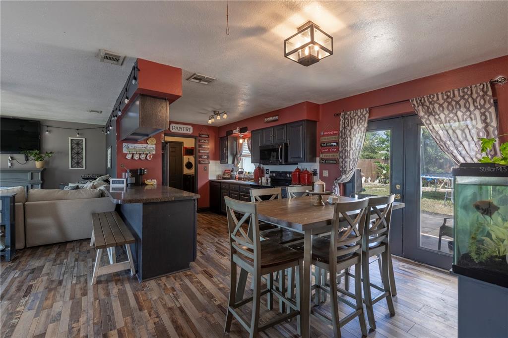 11327 Grove Street Leesburg, FL 34788 - Photo 16 of 40 a view of a dining room with furniture window and outside view