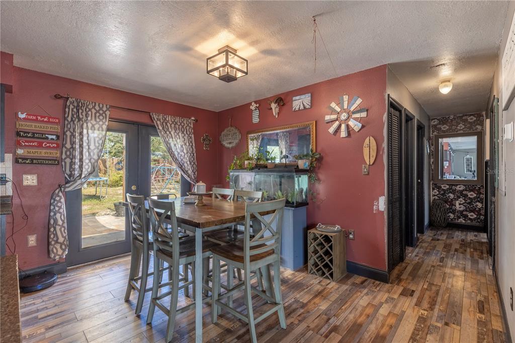 11327 Grove Street Leesburg, FL 34788 - Photo 17 of 40 a view of a dining room with furniture and wooden floor