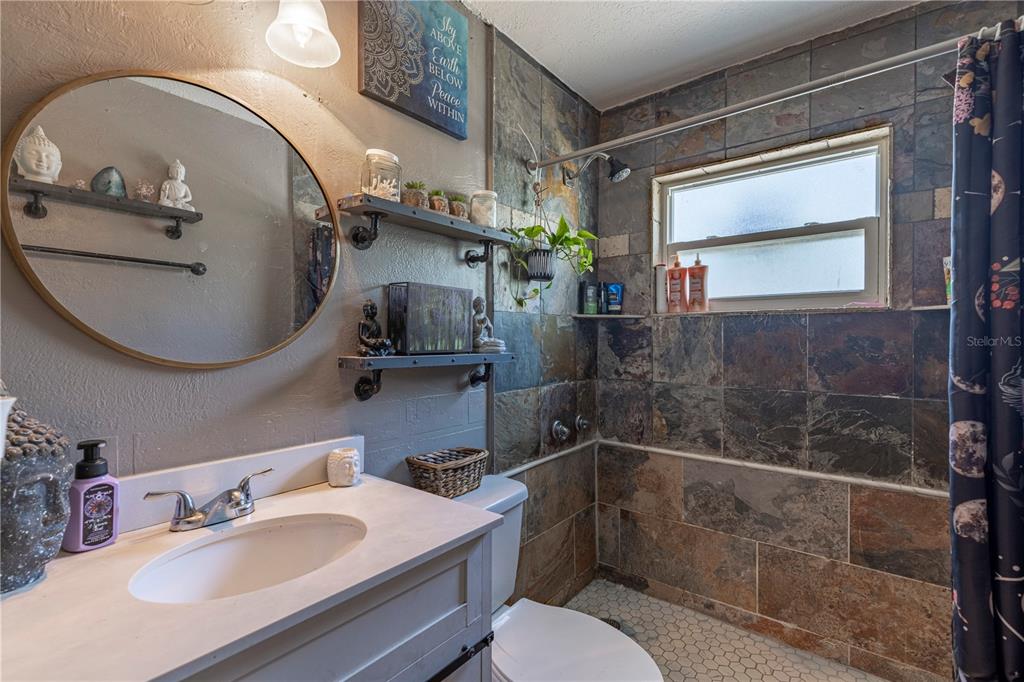 11327 Grove Street Leesburg, FL 34788 - Photo 21 of 40 a bathroom with a sink toilet and shower