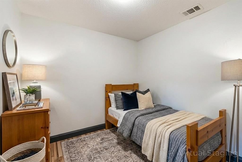 11327 Grove Street Leesburg, FL 34788 - Photo 25 of 40 a bedroom with a bed and a window