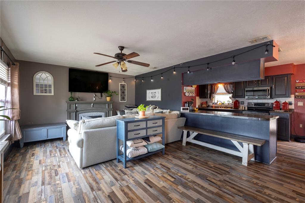 11327 Grove Street Leesburg, FL 34788 - Photo 8 of 40 a living room with furniture and a flat screen tv