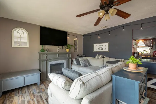 a kitchen with stainless steel appliances granite countertop a stove top oven a sink dishwasher a dining table and chairs with wooden floor