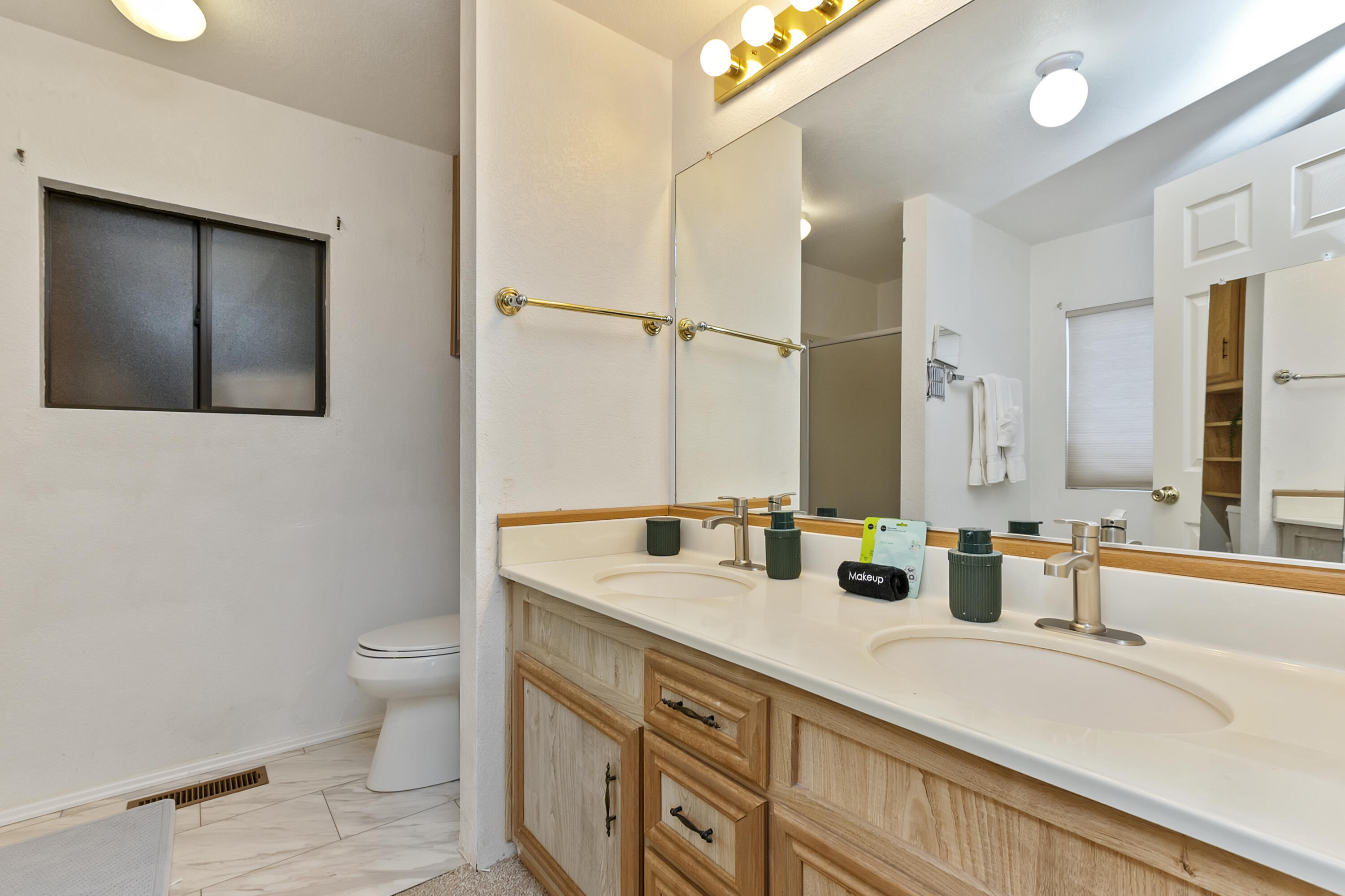74711 Dillon Road, Unit 545 Desert Hot Springs, CA 92241 - Photo 18 of 42 a bathroom with a sink double vanity and a toilet