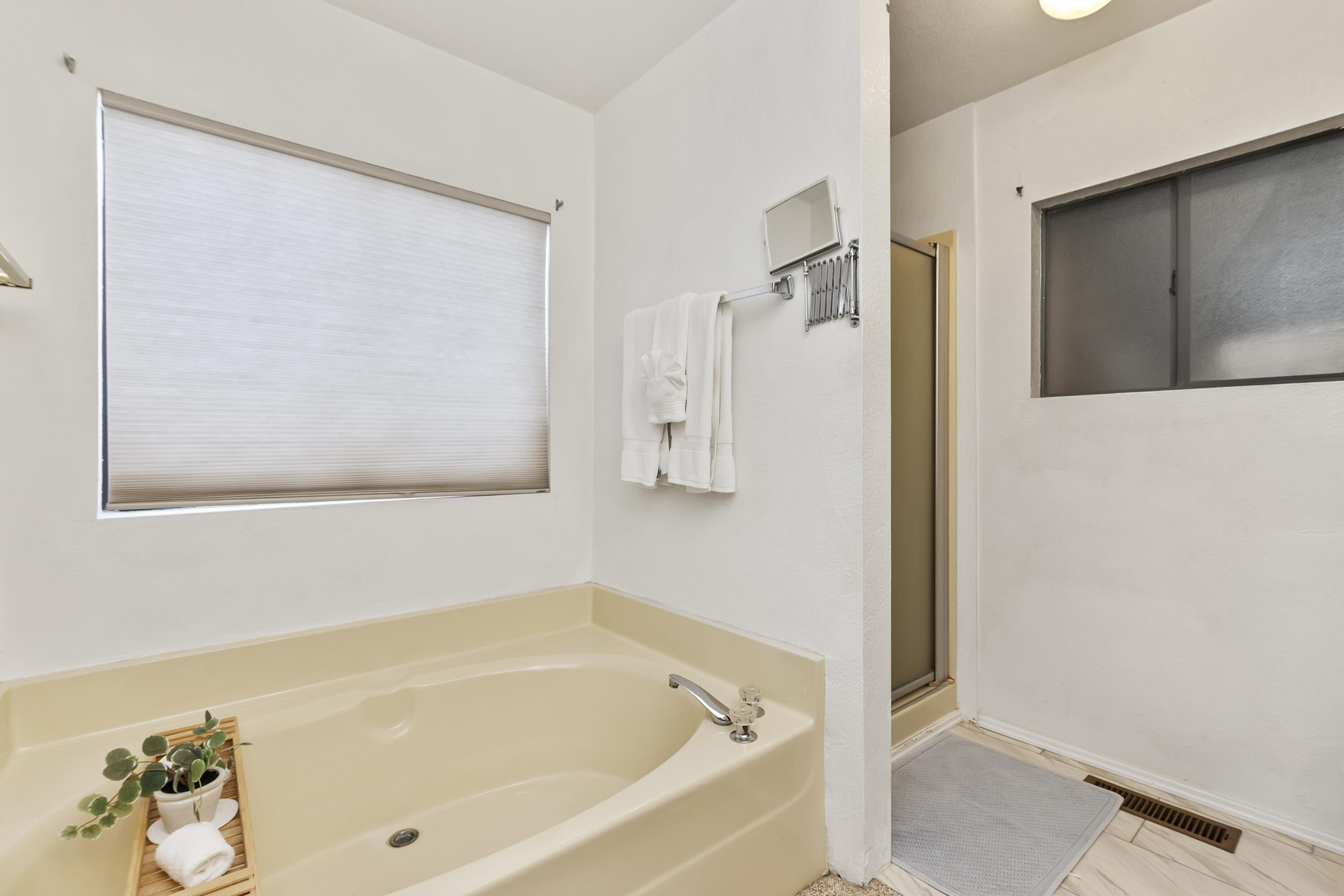 74711 Dillon Road, Unit 545 Desert Hot Springs, CA 92241 - Photo 19 of 42 a bathroom with a tub and shower