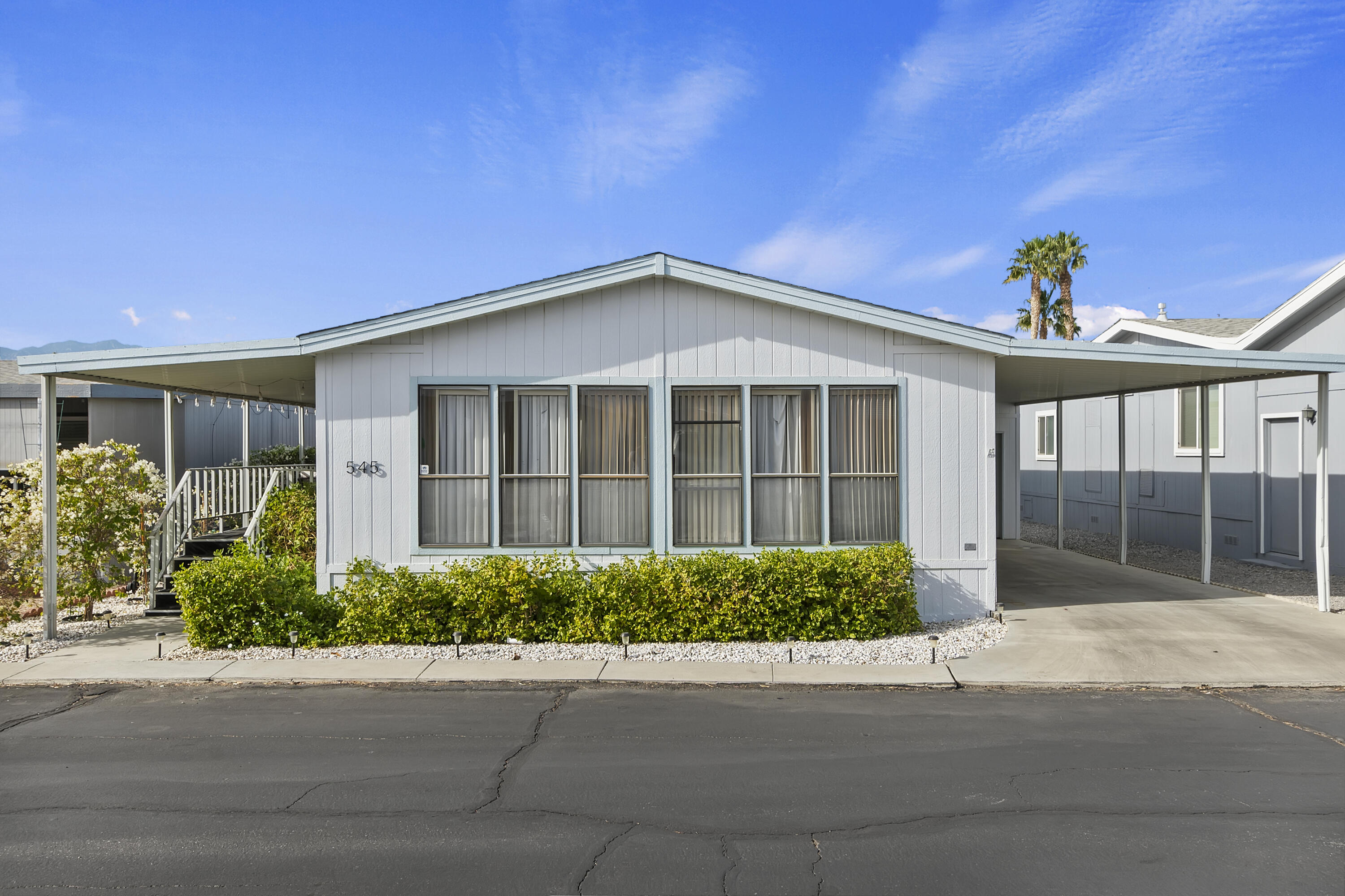 74711 Dillon Road, Unit 545 Desert Hot Springs, CA 92241 - Photo 3 of 42 a front view of a house with a garden