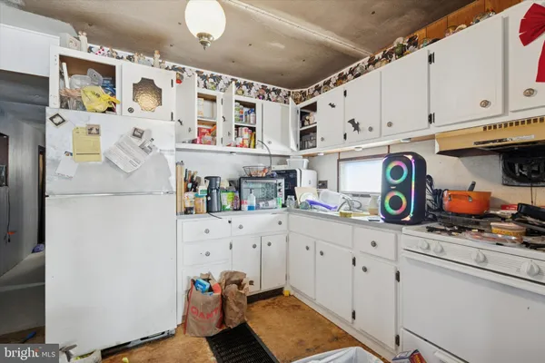 a kitchen with stainless steel appliances granite countertop a refrigerator and a stove