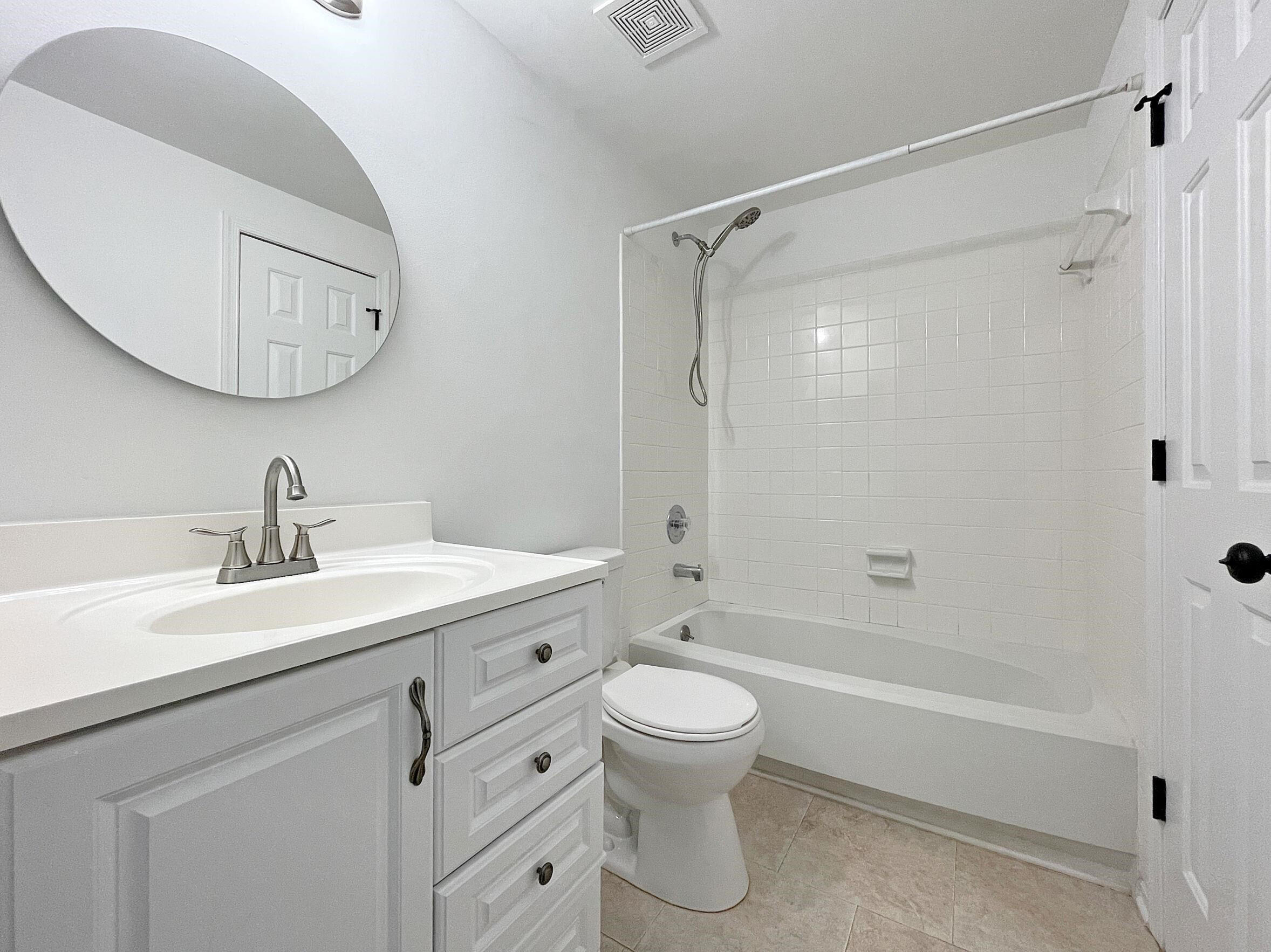 7328 Summerland Drive Raleigh, NC 27612 - Photo 14 of 27 a bathroom with a sink a toilet and a mirror