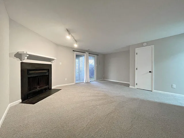 a view of empty room with a fireplace