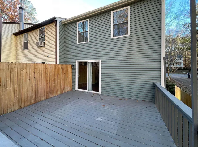 a view of a house with wooden deck