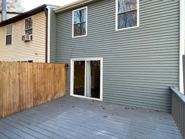 a view of a house with wooden deck