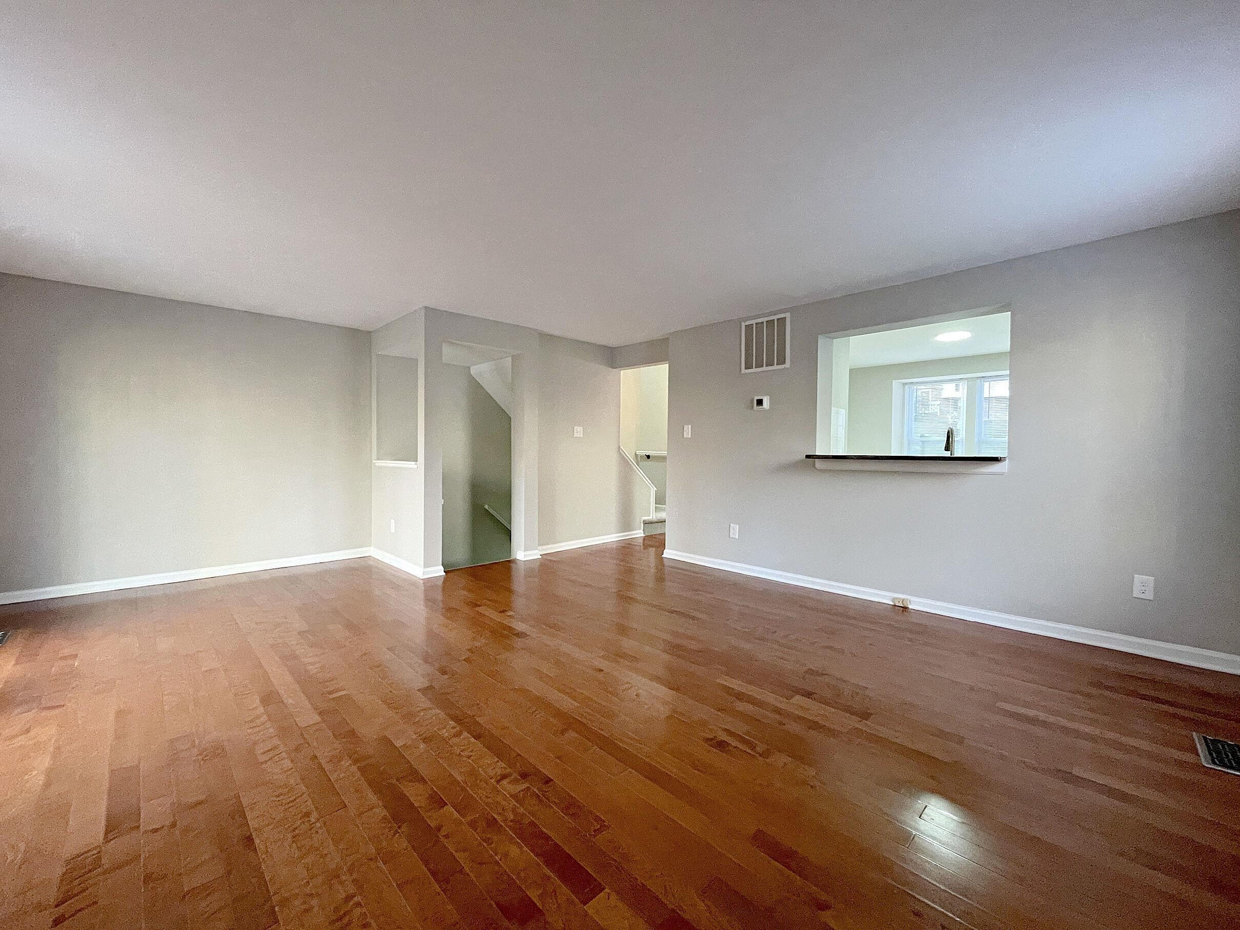 7328 Summerland Drive Raleigh, NC 27612 - Photo 4 of 27 a view of empty room with wooden floor and fan
