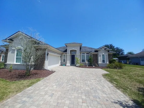 a front view of a house with a garden