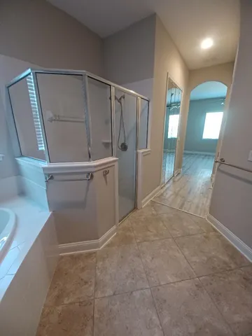 en empty room with wooden floor and mirror