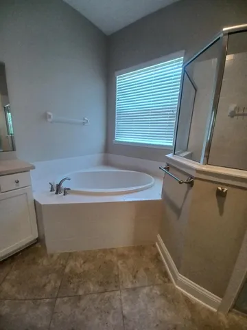 a bath tub sitting in a bathroom next to a window