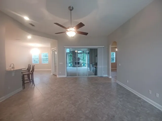 an empty room with furniture and windows