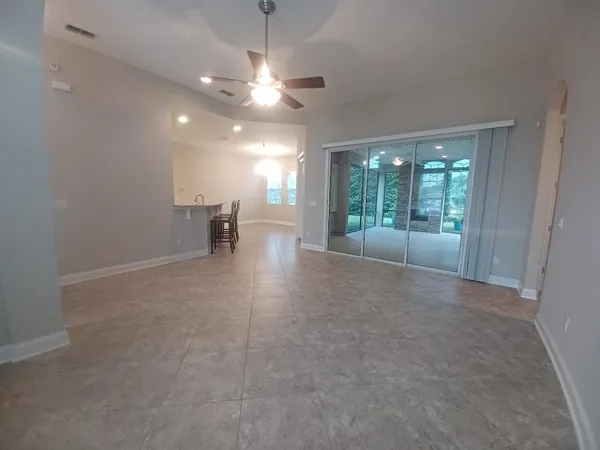 an empty room with entrance and windows