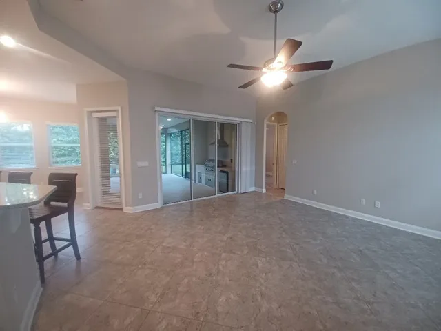 a view of a livingroom with a ceiling fan and window