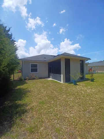 a view of a house with a yard and garage