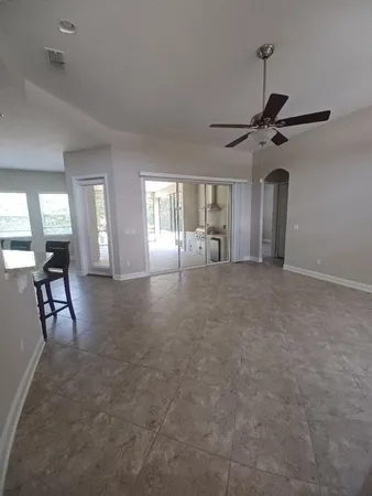 a view of a livingroom with furniture and a ceiling fan