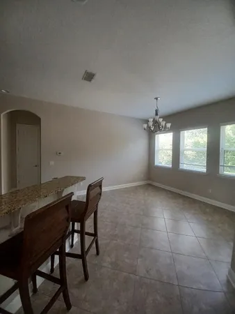a view of a workspace and chandelier in a room