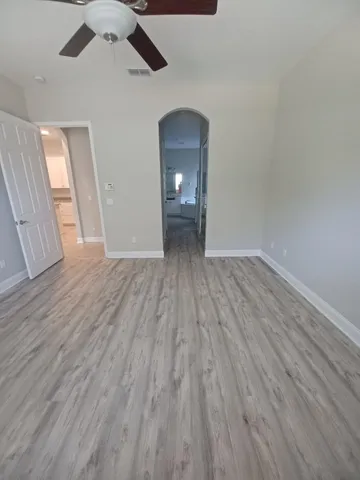 wooden floor in an empty room with a mirror