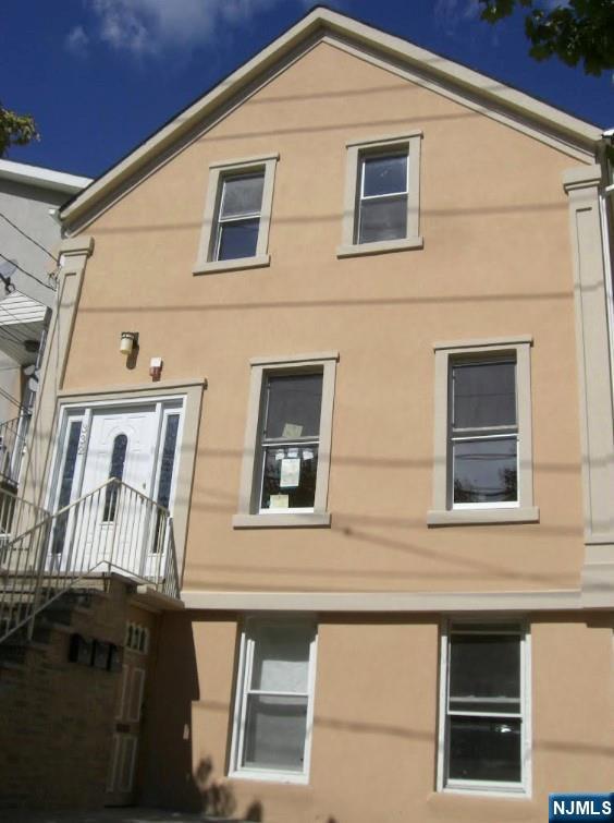 a view of front of a house with large windows
