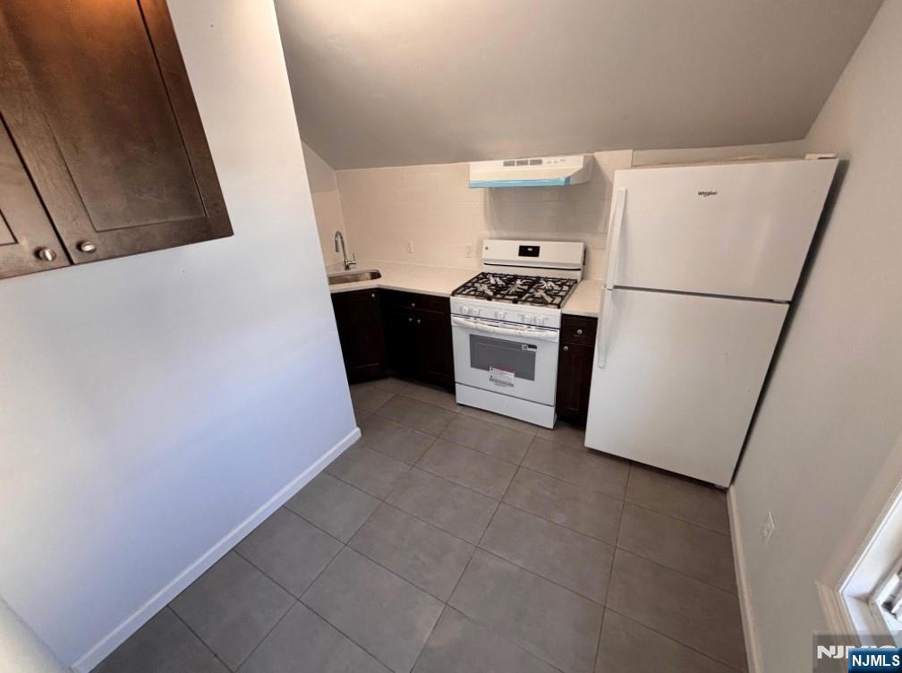 332 70th Street, Unit 2 Guttenberg, NJ 07093 - Photo 6 of 7 a kitchen with granite countertop a refrigerator a sink a stove and dishwasher