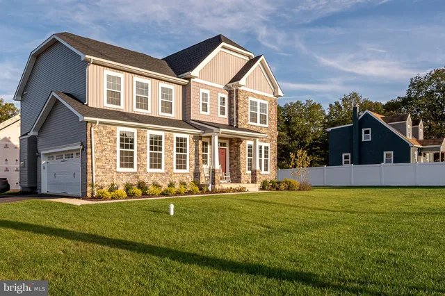 a front view of house with yard and green space