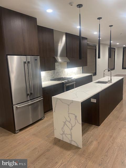 724 Taylor Street Northwest, Unit 1 Washington, DC 20011 - Photo 7 of 36 a kitchen with stainless steel appliances kitchen island granite countertop a refrigerator and a sink