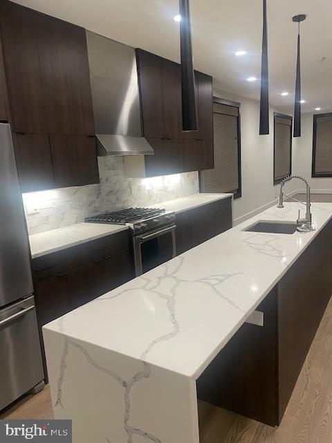 724 Taylor Street Northwest, Unit 1 Washington, DC 20011 - Photo 9 of 36 a kitchen with stainless steel appliances a sink a stove and a refrigerator