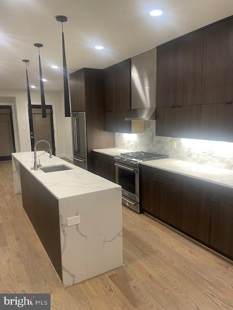 724 Taylor Street Northwest, Unit 1 Washington, DC 20011 - Photo 10 of 36 a kitchen with stainless steel appliances kitchen island a sink stove and refrigerator