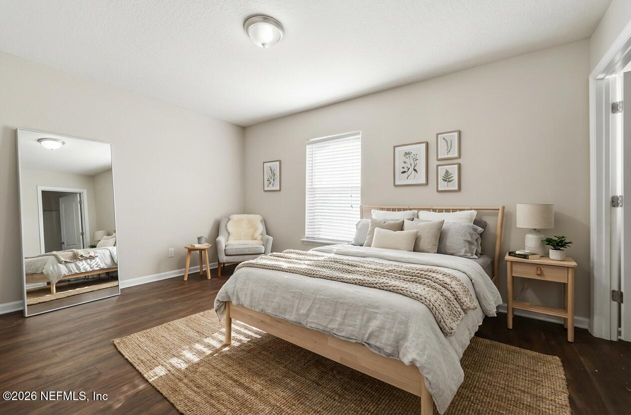76134 Tideview Lane Yulee, FL 32097 - Photo 14 of 44 a bedroom with a bed and wooden floor