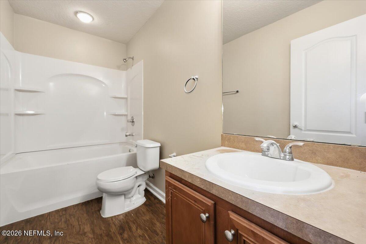76134 Tideview Lane Yulee, FL 32097 - Photo 16 of 44 a bathroom with a sink toilet a mirror and shower