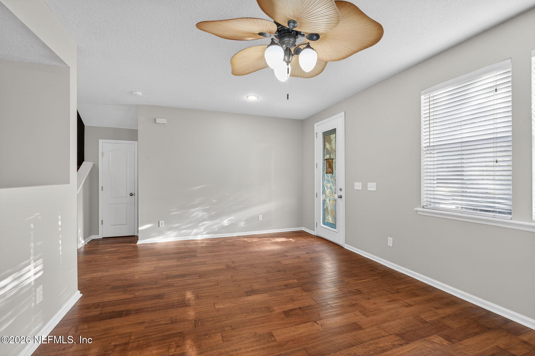 76134 Tideview Lane Yulee, FL 32097 - Photo 19 of 44 a view of an empty room with wooden floor and a window