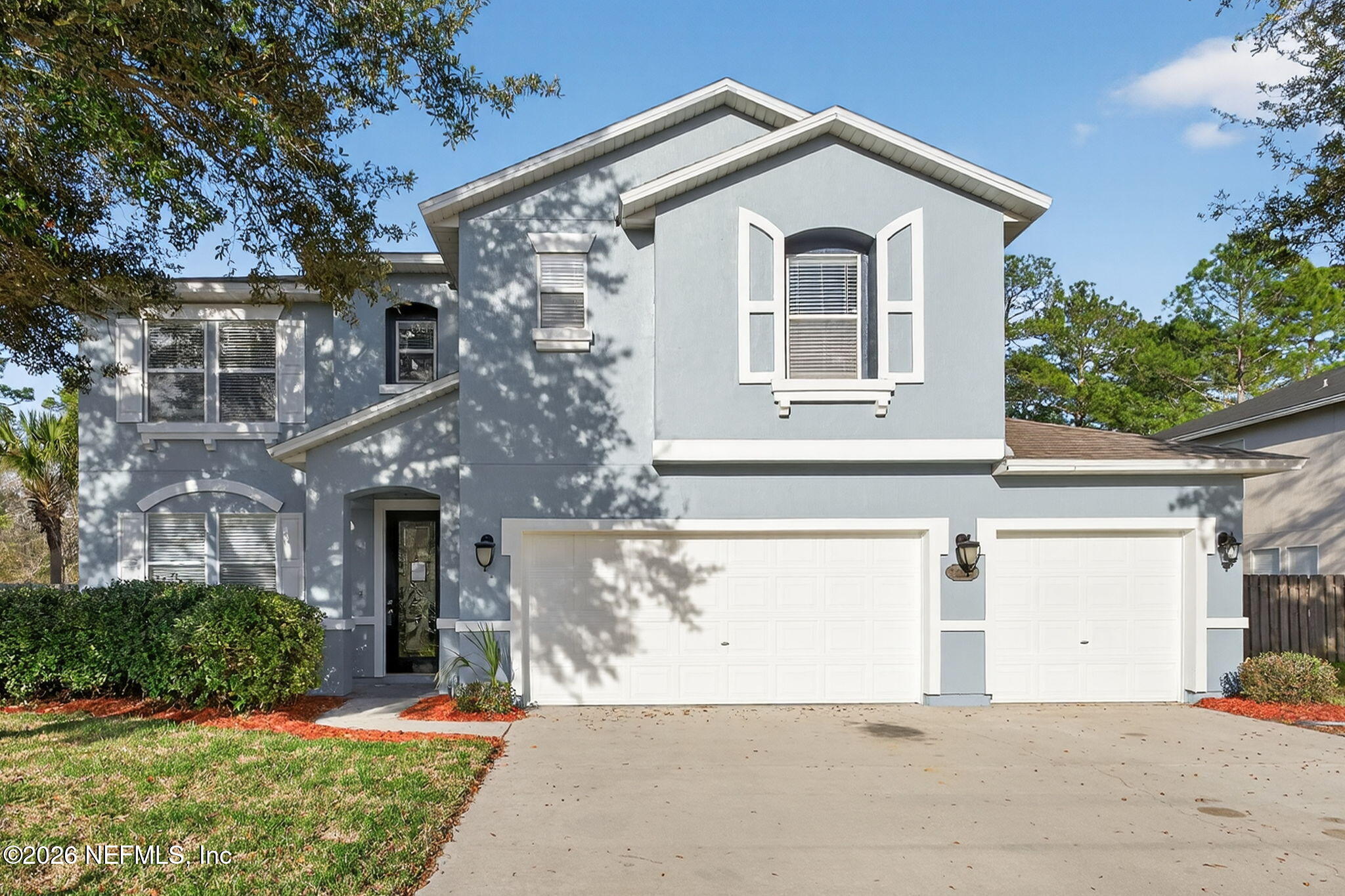 76134 Tideview Lane Yulee, FL 32097 - Photo 2 of 44 a view of a house with a yard and large tree