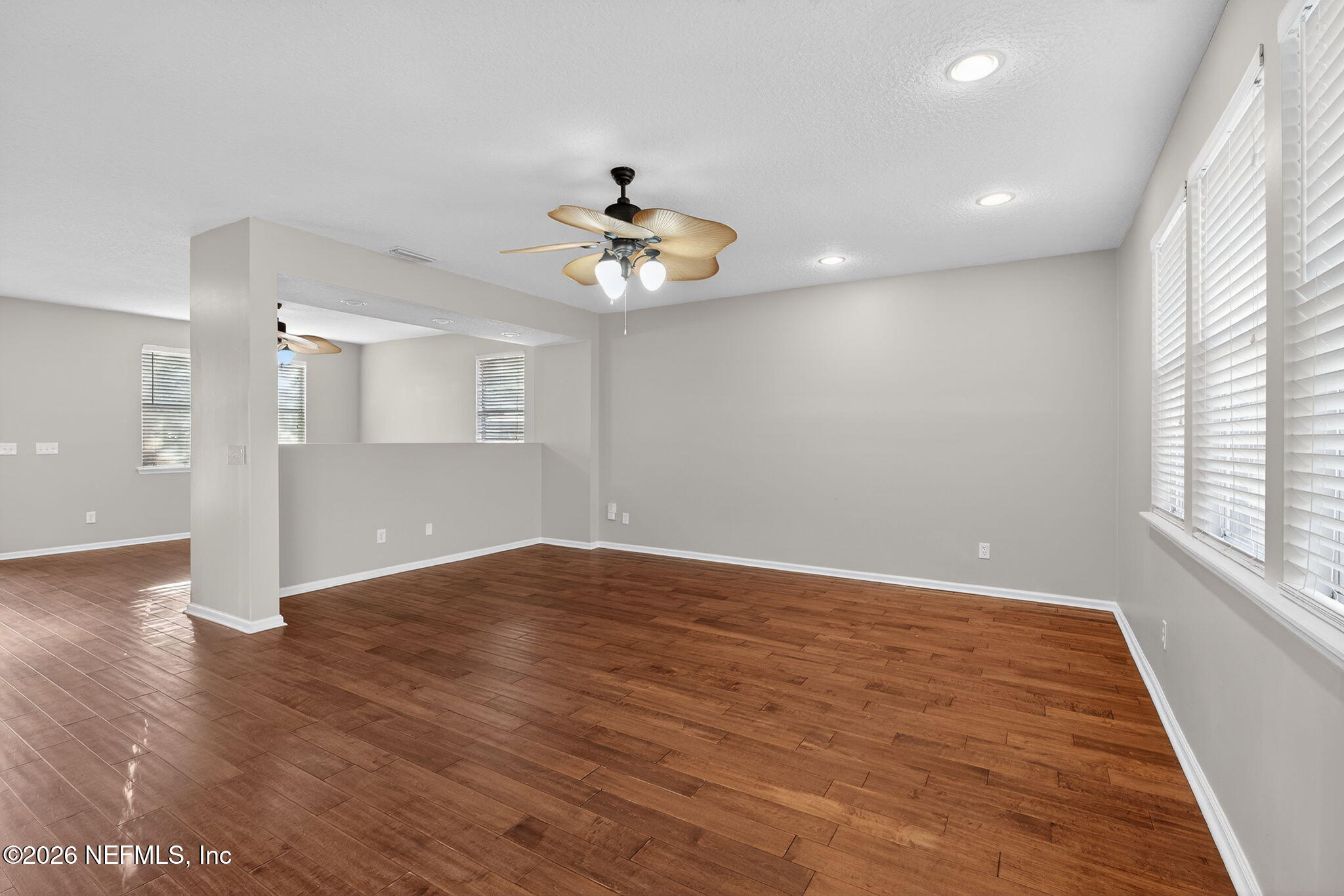 76134 Tideview Lane Yulee, FL 32097 - Photo 24 of 44 an empty room with wooden floor and windows