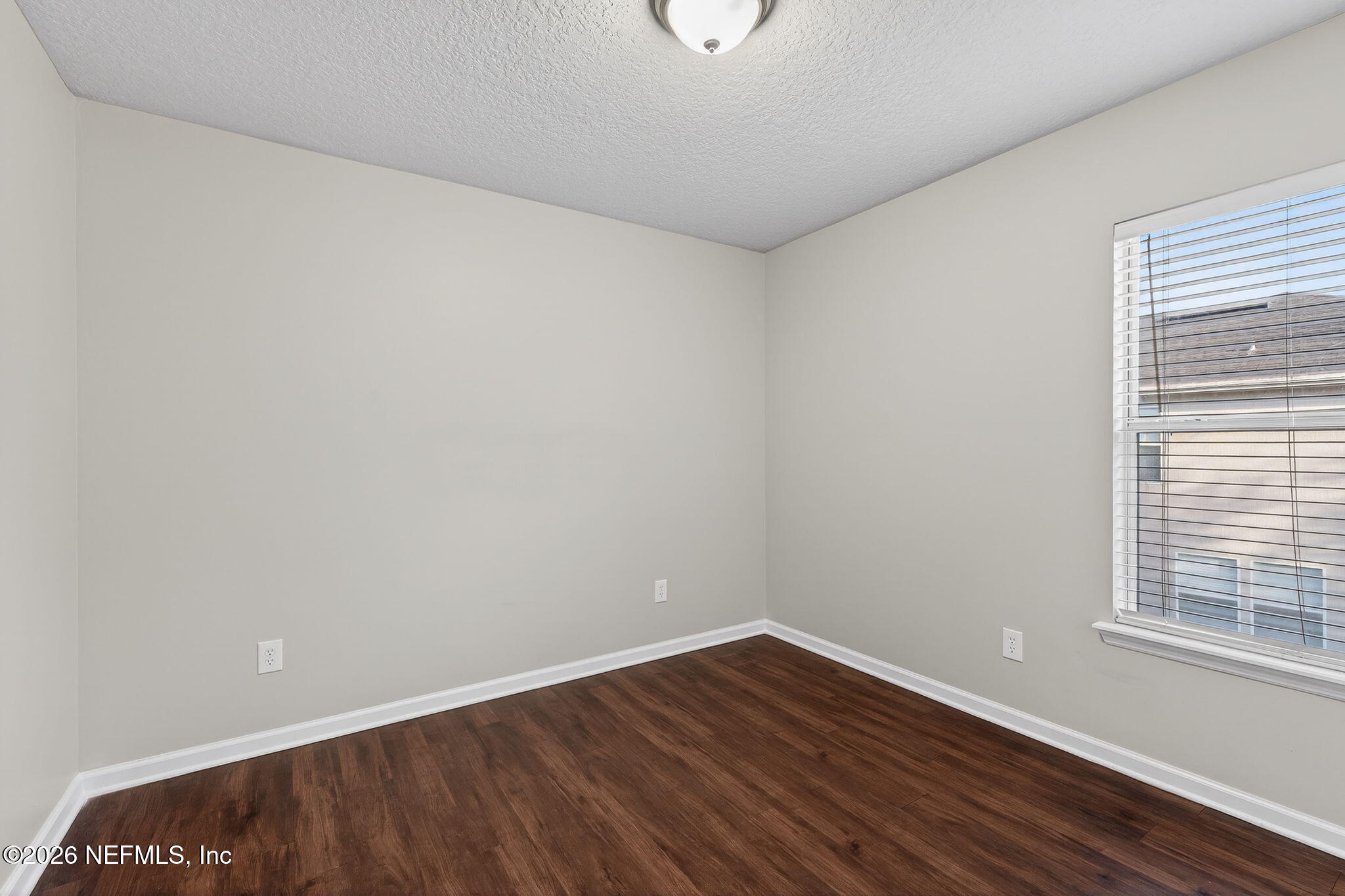 76134 Tideview Lane Yulee, FL 32097 - Photo 33 of 44 a view of an empty room with wooden floor and a window