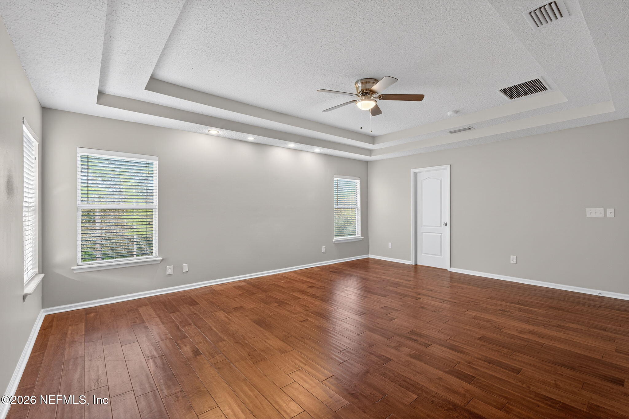 76134 Tideview Lane Yulee, FL 32097 - Photo 35 of 44 a view of an empty room with wooden floor and a window