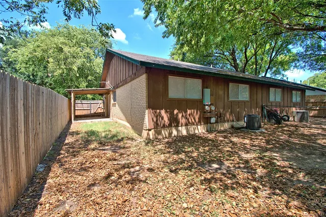 a backyard of a house with bicycles parked and swing