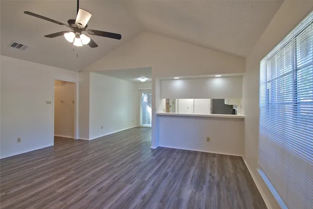 a kitchen with a refrigerator sink and cabinets