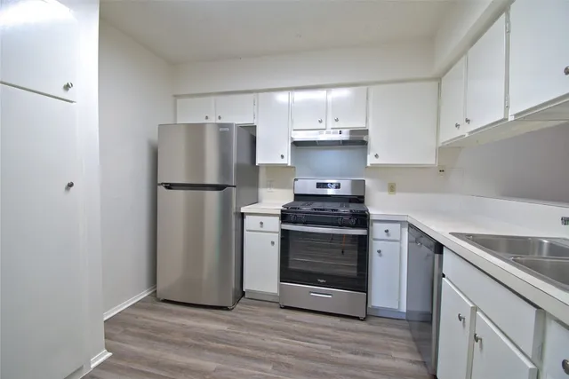 a kitchen with a sink stainless steel appliances and cabinets