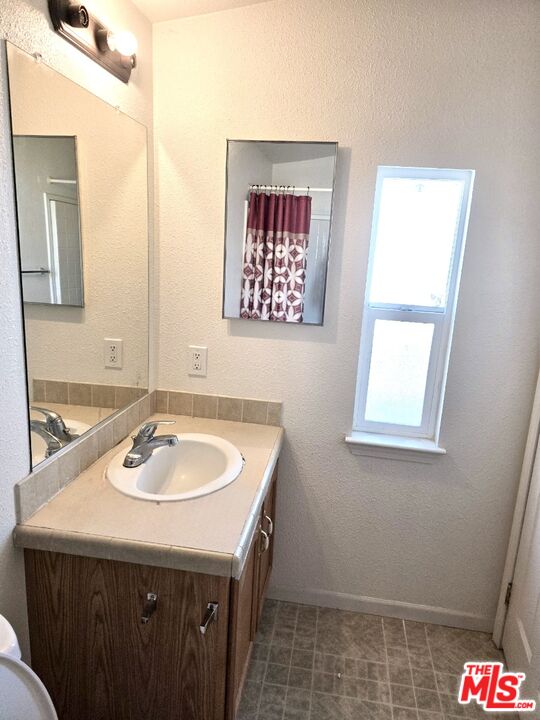 17700 South Avalon Boulevard, Unit 422 Carson, CA 90746 - Photo 16 of 17 a bathroom with a sink a vanity and a mirror