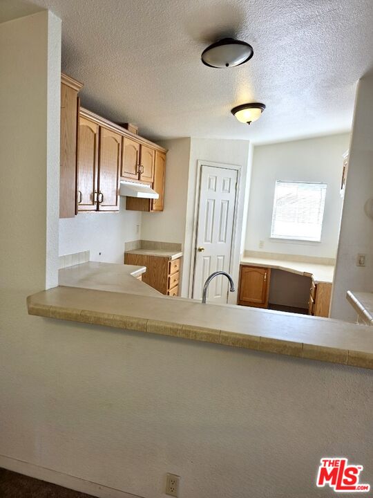 17700 South Avalon Boulevard, Unit 422 Carson, CA 90746 - Photo 6 of 17 a kitchen with stainless steel appliances granite countertop a sink a stove and a refrigerator