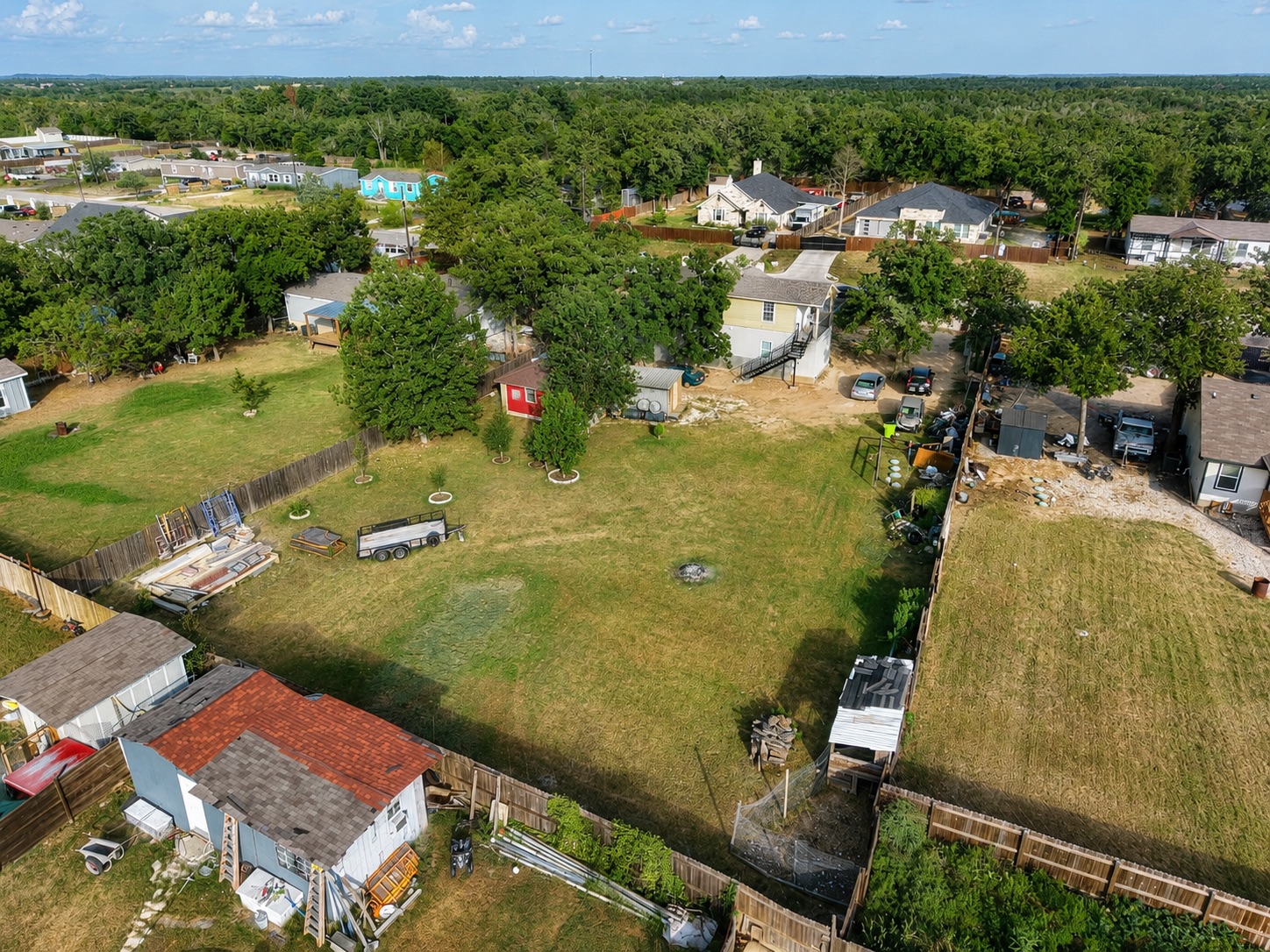 158 Buena Fortuna Road Elgin, TX 78621 - Photo 16 of 40 An aerial perspective reveals a residential area with varied housing and lush green spaces.