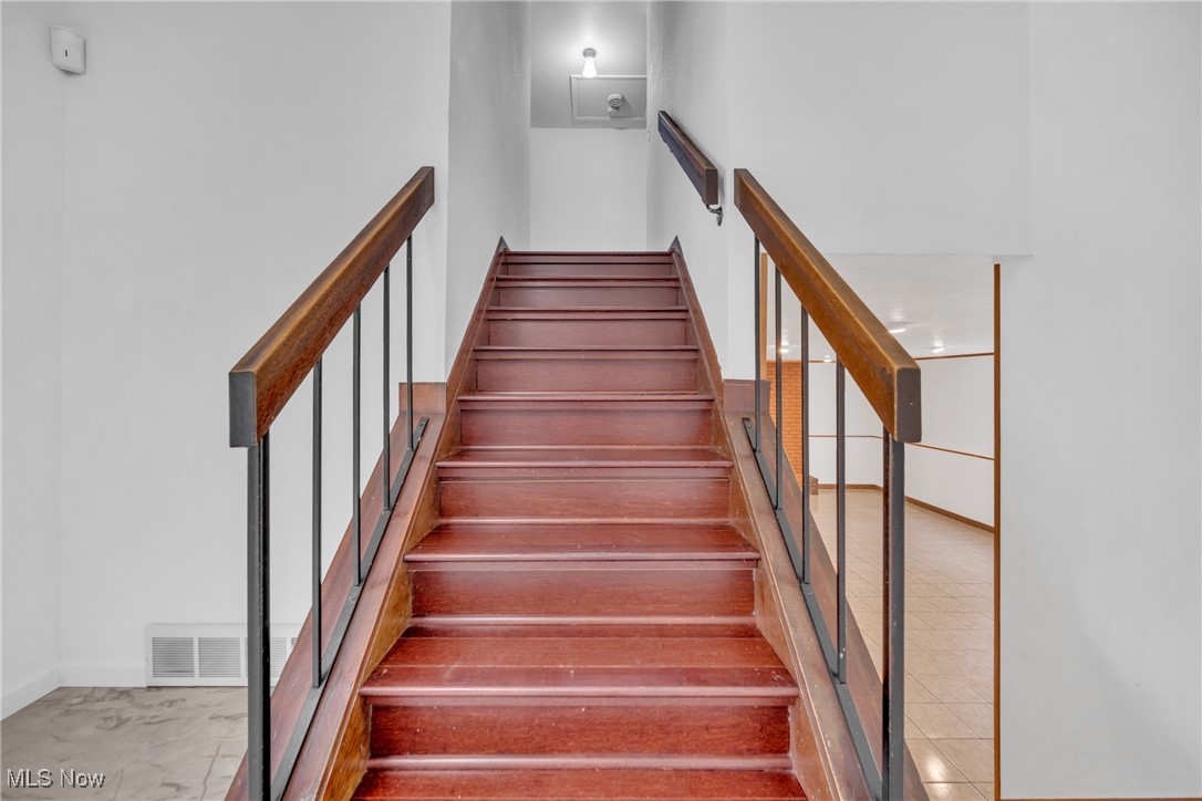 5910 Som Center Road Solon, OH 44139 - Photo 46 of 50 Stairway with a towering ceiling and tile patterned floors