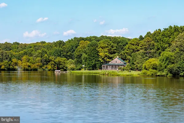 a view of a lake with houses in the back