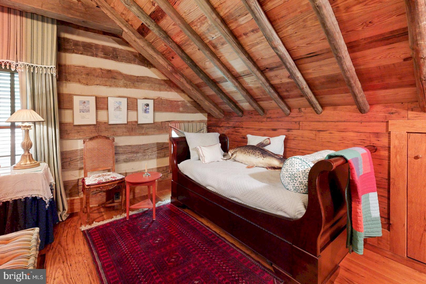 6150 Oxford Road Easton, MD 21601 - Photo 24 of 52 a bed room with a bed and a chair