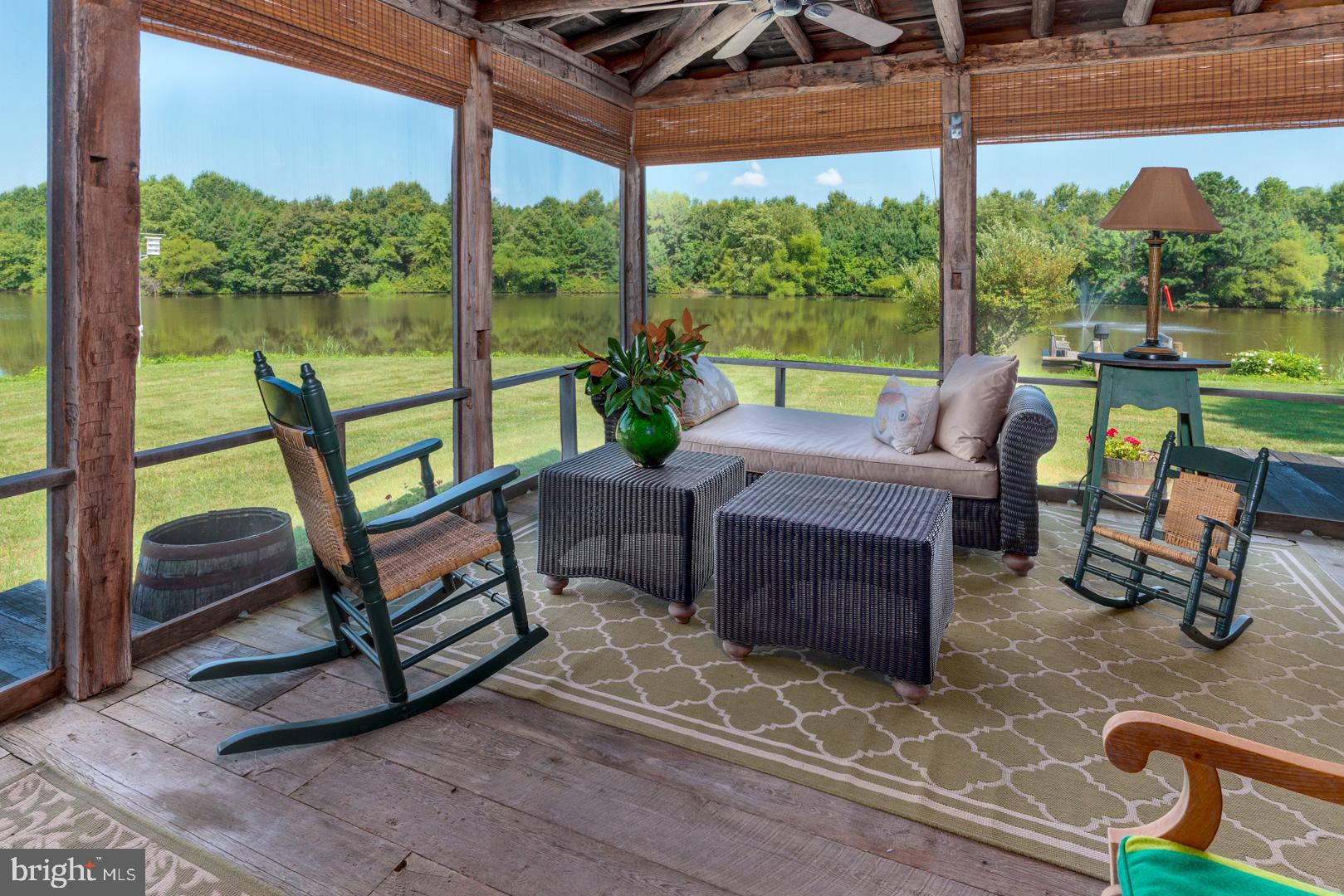 6150 Oxford Road Easton, MD 21601 - Photo 26 of 52 a outdoor space with the couches and dining table with the garden view